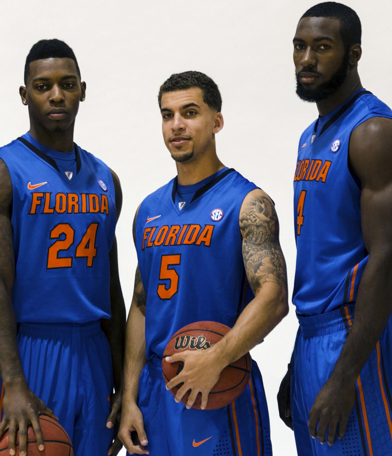 Scottie Wilbekin (center) poses for a photo with Casey Prather (left) and Patric Young (right) during Florida’s basketball media day on Oct. 9. Prather will miss Saturday's game, Wilbekin is questionable and Young will see limited minutes.