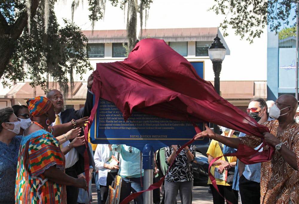 <p>A historical marker is unveiled at the Alachua County Administration Building on Saturday, Oct. 23, 2021. The marker commemorates victims of lynching and says that at least 12 Black people were lynched in Gainesville.<br/></p>