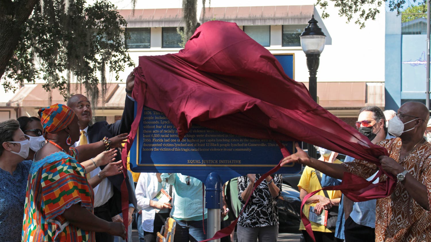 A historical marker is unveiled at the Alachua County Administration Building on Saturday, Oct. 23, 2021. The marker commemorates victims of lynching and says that at least 12 Black people were lynched in Gainesville.