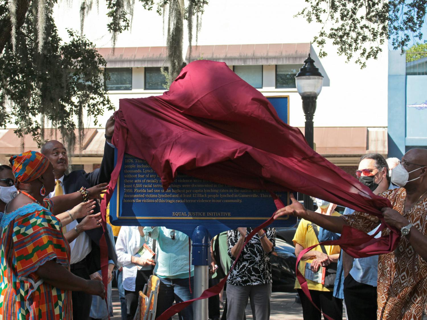 A historical marker is unveiled at the Alachua County Administration Building on Saturday, Oct. 23, 2021. The marker commemorates victims of lynching and says that at least 12 Black people were lynched in Gainesville.