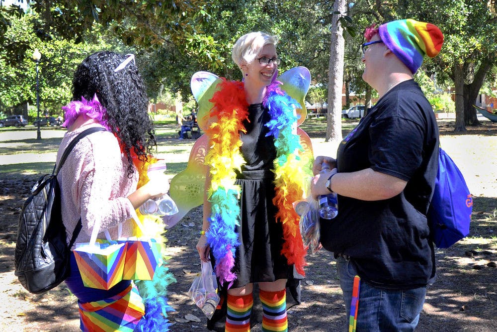 STRIVE members Kelly Selwyn, 26, Sarah Boeshart, 25, and Kelsey Roman, 20, pass out buttons and contraceptives to pedestrians in Plaza of the Americas. The three UF students were there to promote their organization's goal of preventing interpersonal violence on campus.