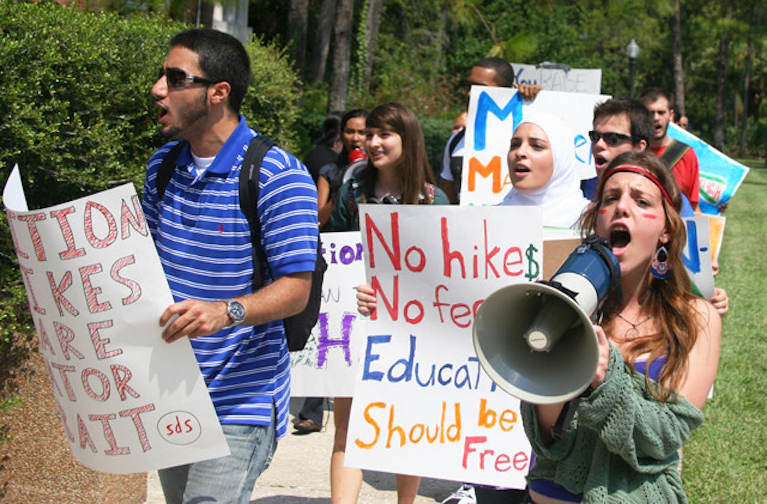 Members of Students for a Democratic Society protest tuition hikes around UF's campus Friday afternoon.