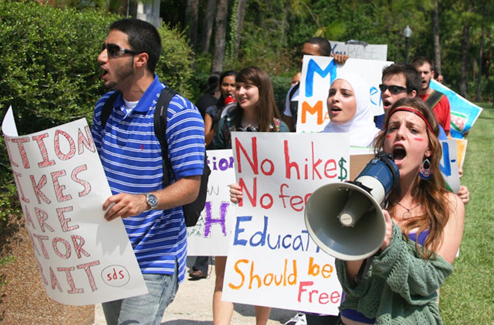 <p>Members of Students for a Democratic Society protest tuition hikes around UF's campus Friday afternoon.</p>