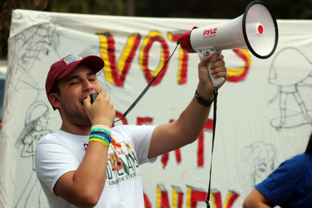 Alex Wind, 17, a student at Marjory Stoneman Douglas High School and the project strategist for “March for Our Lives,” leads the rally outside of Ted Yoho's office. 