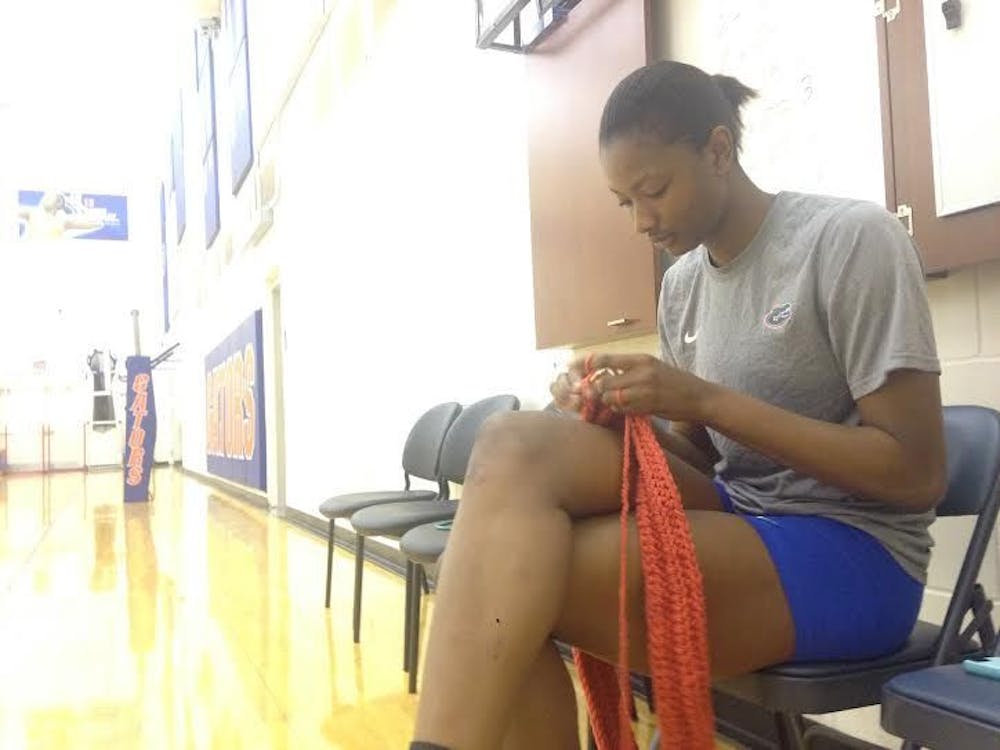 <p>UF middle blocker Rhamat Alhassan knits before practice on Oct. 21, 2015,&nbsp;in the Lemerand Practice Facility.</p>