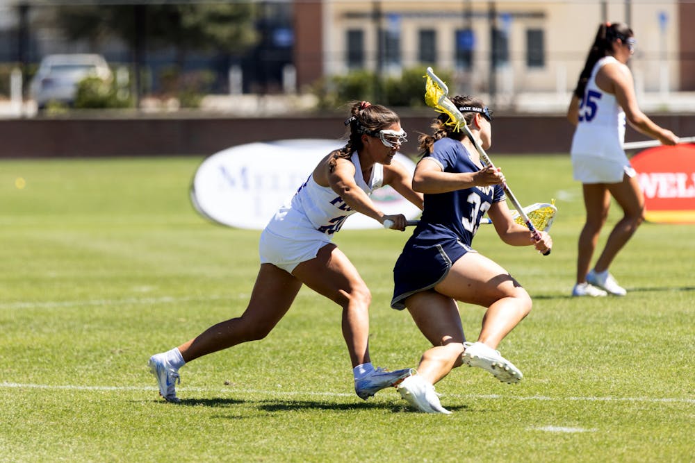 UF Women’s Lacrosse defender Celeste Forte (20) guards Emily Messinese (33) of the Naval Academy on Wednesday, March 12th, 2025.
