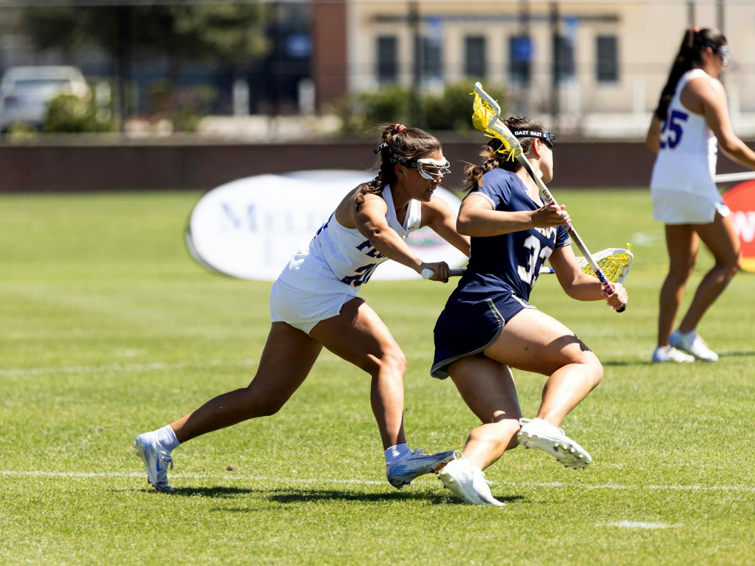 UF Women’s Lacrosse defender Celeste Forte (20) guards Emily Messinese (33) of the Naval Academy on Wednesday, March 12th, 2025.