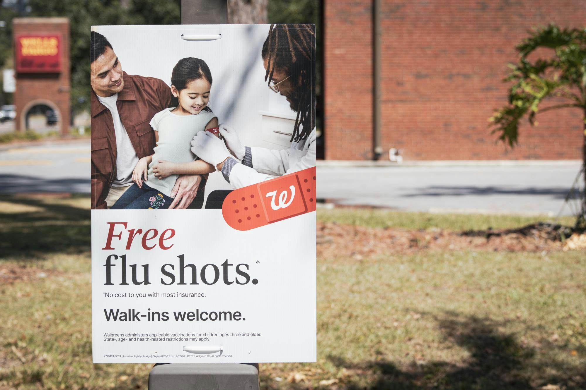 A sign reads "free flu shots" outside of Walgreenes.