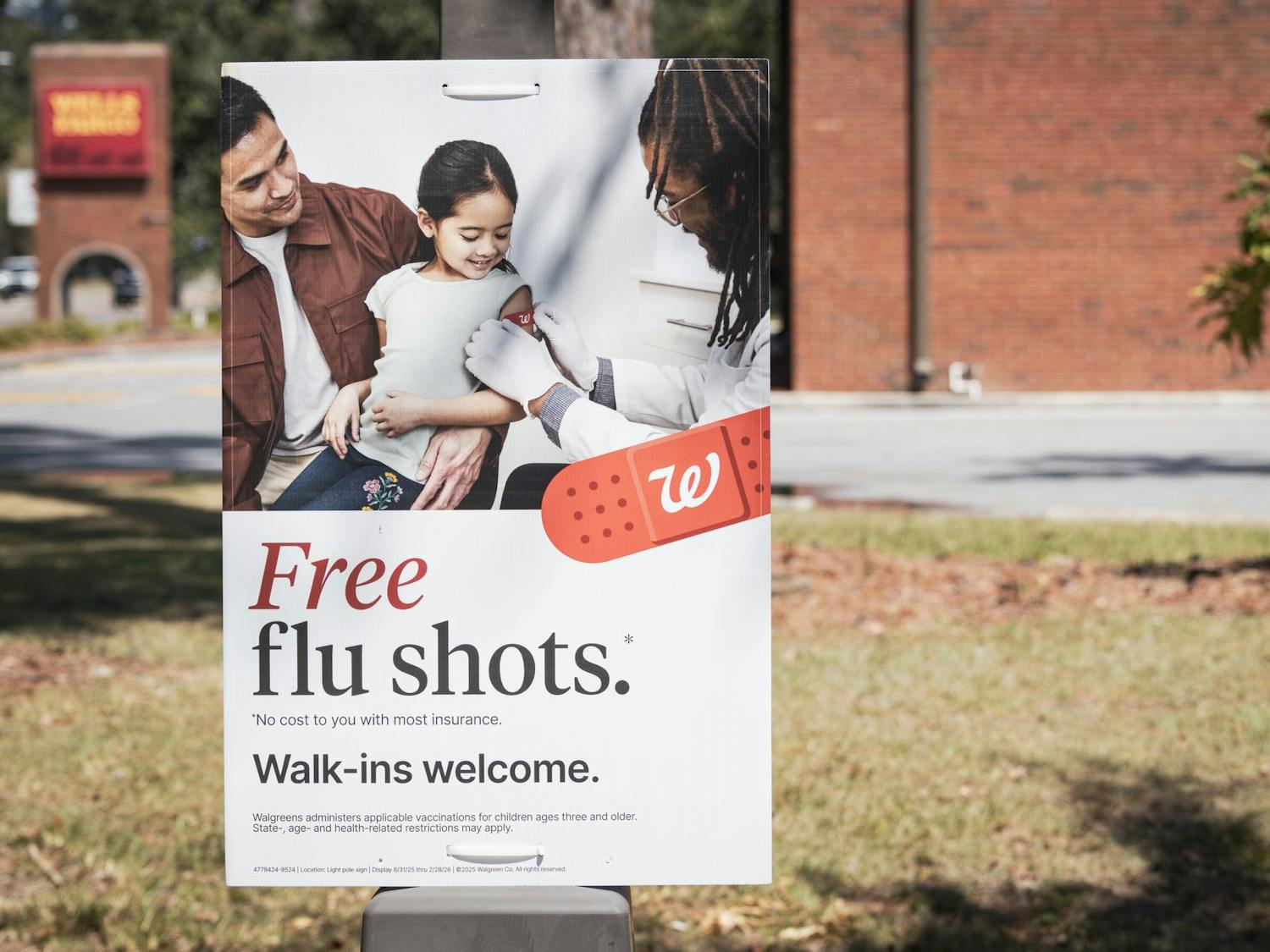 A sign reads "free flu shots" outside of Walgreenes.