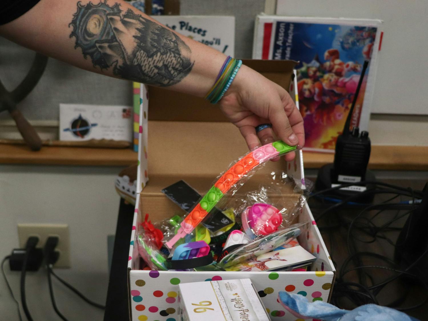 The treasure box in Ashley Axson's classroom features pop-its and other fidget toys her students can earn with good behavior and hard work.