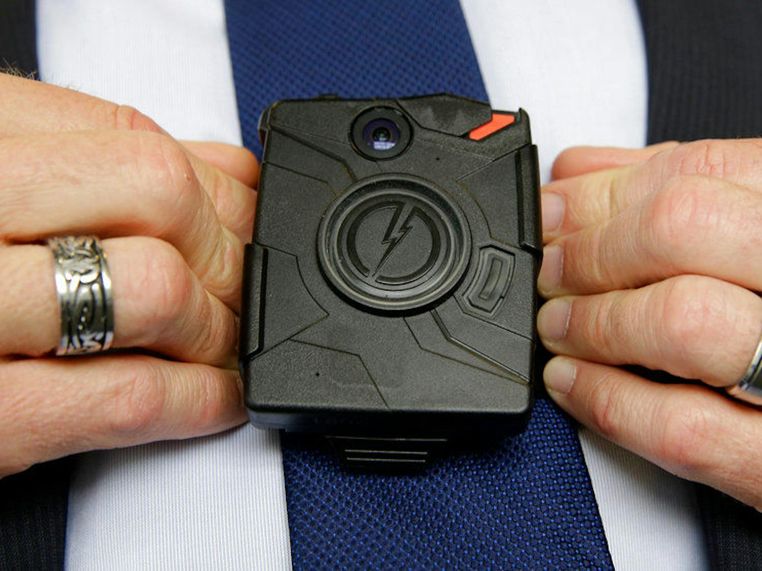 In this Feb. 19, 2015 file photo, Steve Tuttle, vice president of communications for Taser International, demonstrates one of the company's body cameras during a company-sponsored conference at the California Highway Patrol headquarters in Sacramento, Calif.&nbsp;