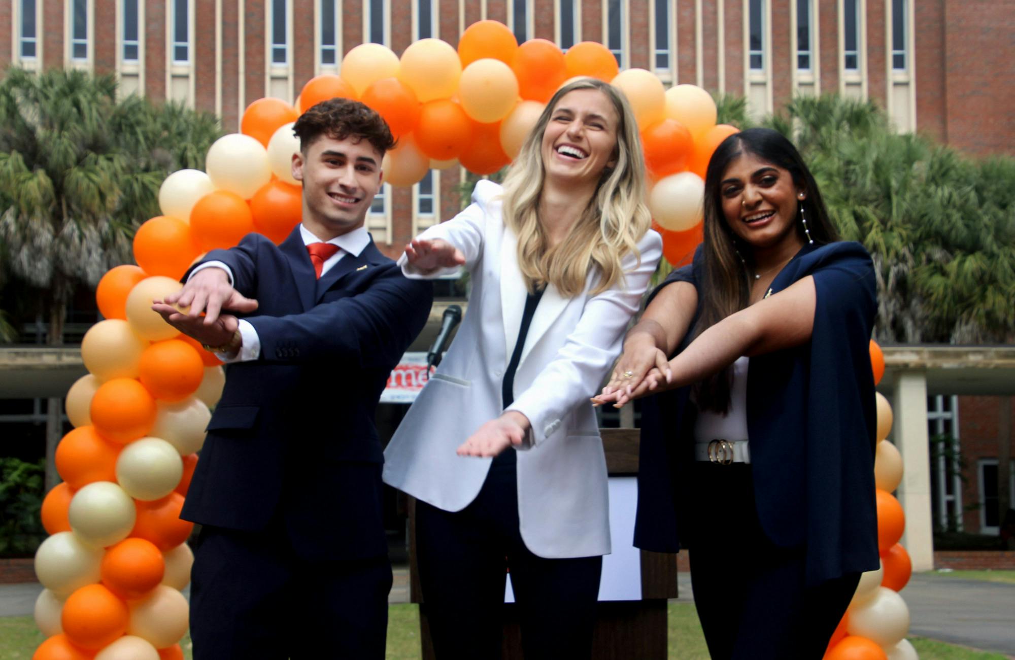 Daniel Badell, Lauren Lemasters and Sierra Kantamneni (left to right) pose for a photo outside of Library West at the annoucement of Gator Party's executive ticket for Student Government on Wednesday, Jan. 26. Badell is running for vice president, Lemasters for president and Kantamneni for treasurer.