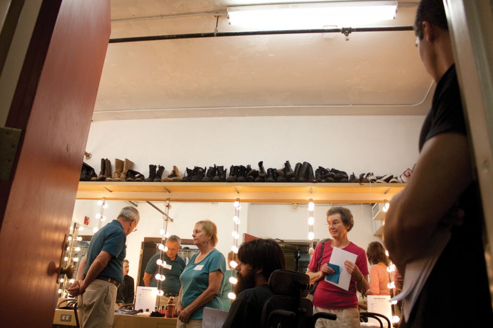 Visitors look around one of the backstage dressing rooms on the behind-the-scenes tour of the Hippodrome Theatre in downtown Gainesville on Friday.