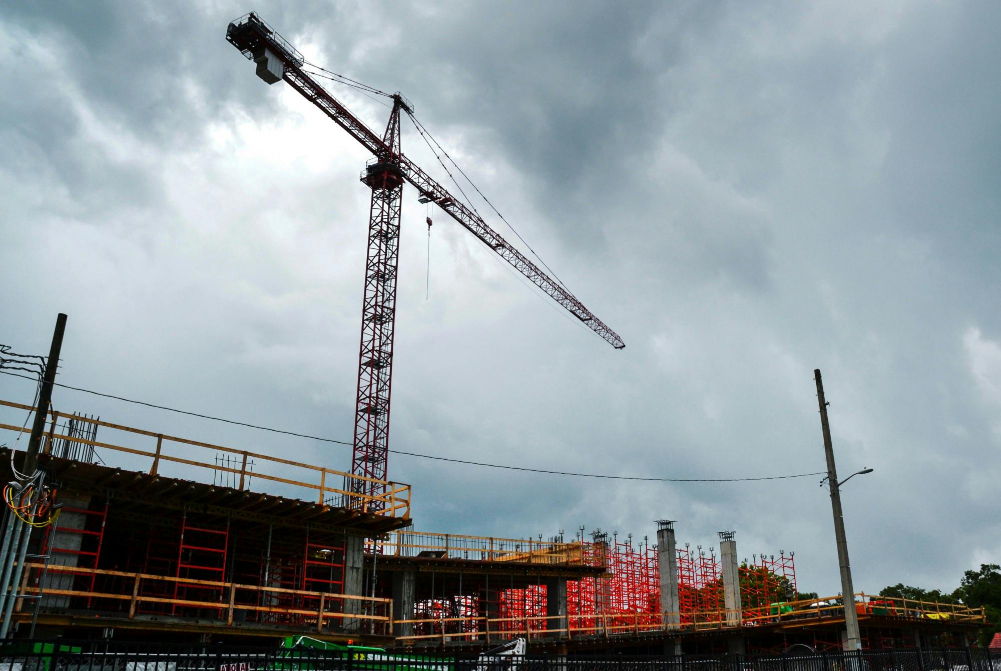 A crane towers over the Evolve apartment complex construction site at 931 West University Avenue on Tuesday, June 16, 2021. Evolve is one of several new mid-rise apartment complexes under construction in midtown and downtown Gainesville.