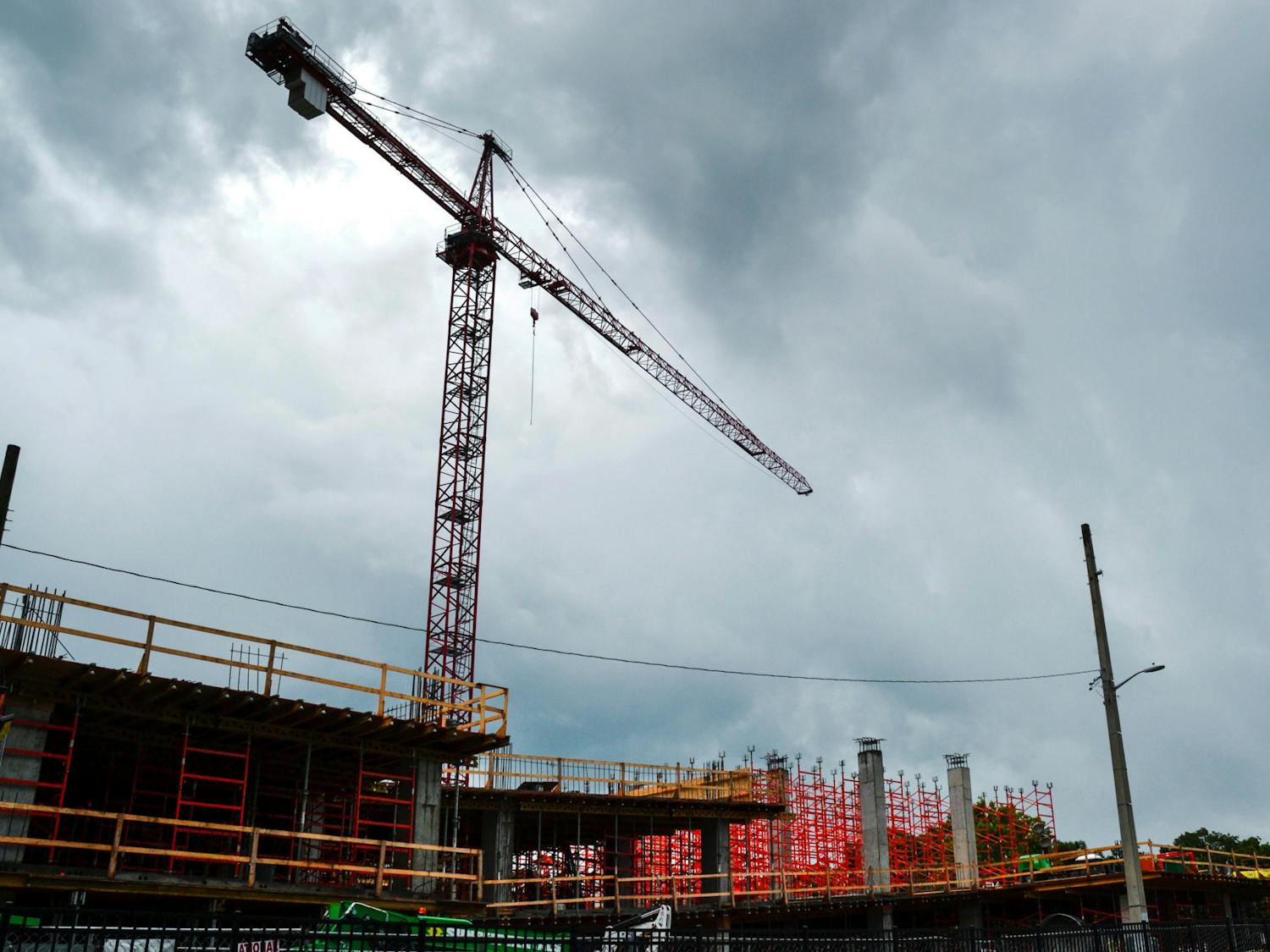 A crane towers over the Evolve apartment complex construction site at 931 West University Avenue on Tuesday, June 16, 2021. Evolve is one of several new mid-rise apartment complexes under construction in midtown and downtown Gainesville.