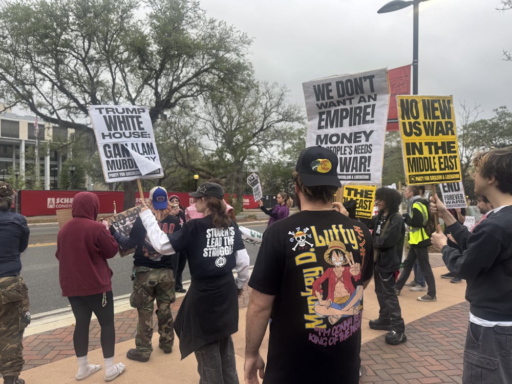 Protestors against the U.S. war in Iran gather in front of the Alachua County Clerk’s Office, Wednesday, April 8, 2026, in Gainesville, Fla.