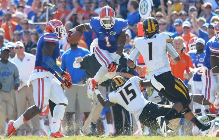 Linebacker Jon Bostic (1) attempts to hurdle Missouri wideout Dorial Green-Beckham (15) after making an interception during the fourth quarter of Florida’s 14-7 win on Saturday at Ben Hill Griffin Stadium.