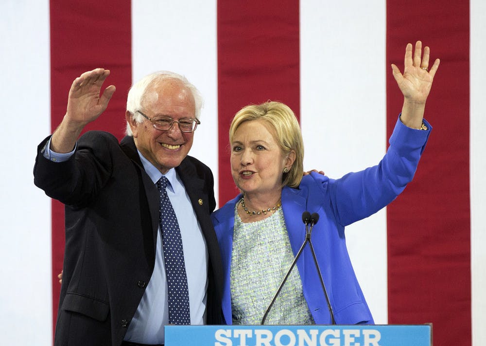 <p>Democratic presidential candidate Hillary Clinton waves to supporters with Sen. Bernie Sanders, I-Vt., during a rally in Portsmouth, N.H., Tuesday, July 12, 2016, where Sanders endorsed her for president.</p>