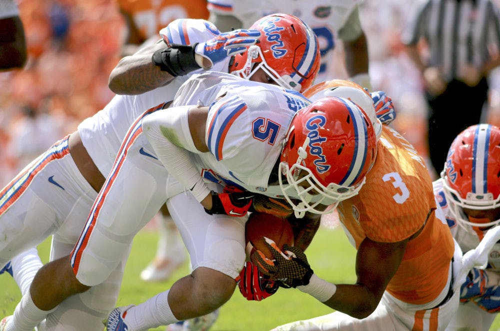 Freshman cornerback Jalen Tabor tackles Tennessee wide receiver Josh Malone during Florida's 10-9 victory against Tennessee on Saturday at Neyland Stadium in Knoxville.