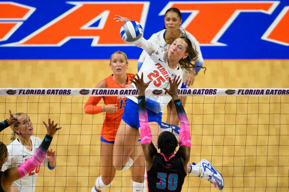 Florida middle blocker Alec Rothe hits during an NCAA Volleyball match against FAU, Friday, Sept. 11, 2026, in Gainesville, Fla.