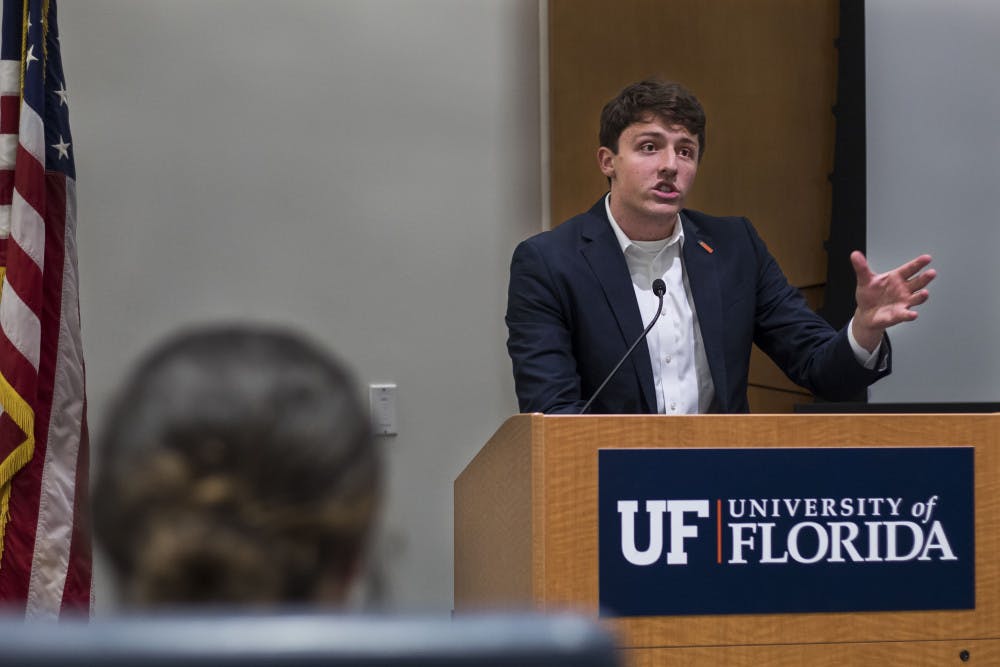 Nik Bindi, CLAS Senator and Deputy Minority Party Leader, speaks Tuesday night at the first Student Government meeting of Fall semester about upcoming fall legislation on SG reapportionment to better reflect the populations of voting districts. About 100 people attended the meeting.