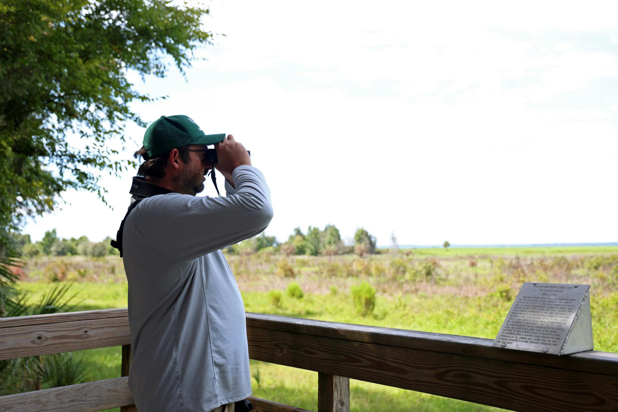 Anthony Lee searches for a Short-tailed Hawk on the observation tower at Paynes Prairie Preserve State Park on Wednesday, Sept. 5, 2025.