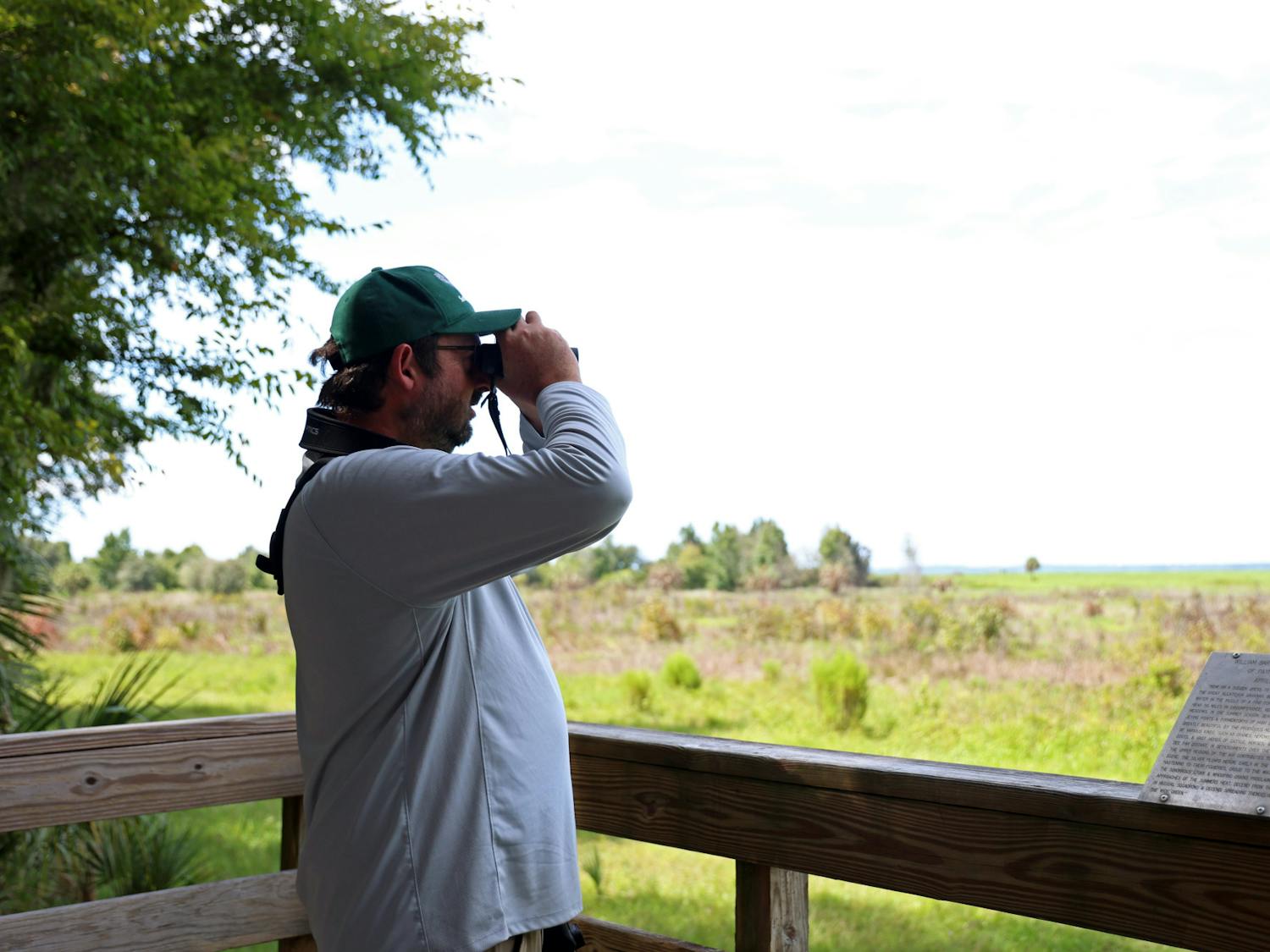 Anthony Lee searches for a Short-tailed Hawk on the observation tower at Paynes Prairie Preserve State Park on Wednesday, Sept. 5, 2025.