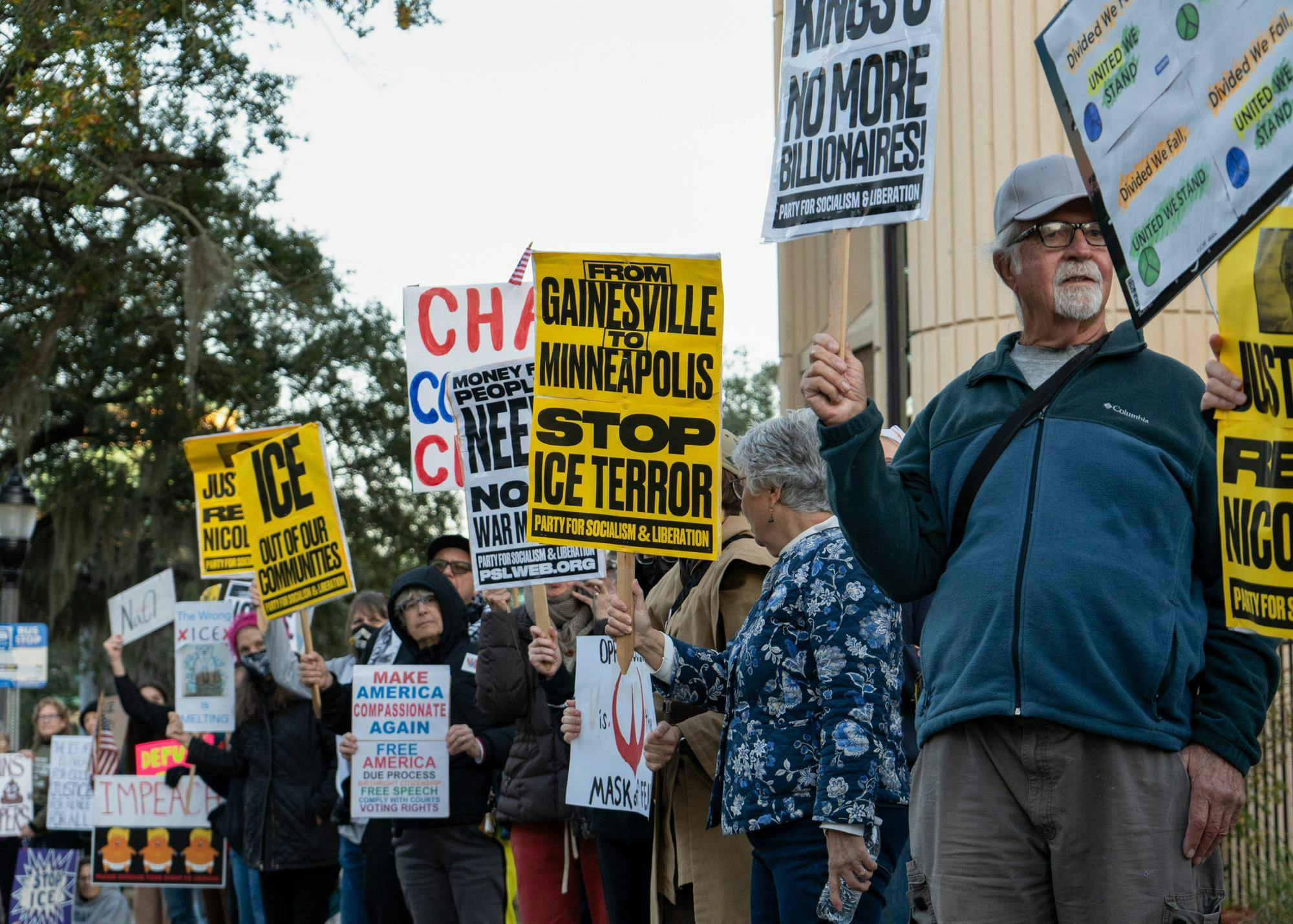 Protesters raise their signs at the ICE protest in Gainesville, Fla., Tuesday, Jan. 20, 2026.Protesters raise their signs and chant at the ICE protest in Gainesville, Fla., Tuesday, Jan. 20, 2026.