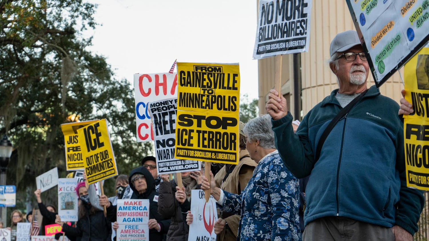 Protesters raise their signs at the ICE protest in Gainesville, Fla., Tuesday, Jan. 20, 2026.Protesters raise their signs and chant at the ICE protest in Gainesville, Fla., Tuesday, Jan. 20, 2026.