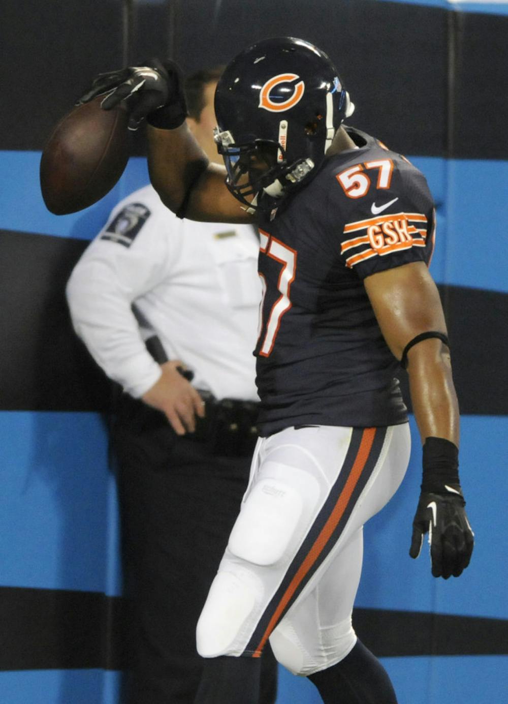 <p>Chicago Bears' Jon Bostic (57) spikes the ball in the end zone after returning an interception for a touchdown against the Carolina Panthers during the first half of a preseason NFL football game in Charlotte, N.C., on Aug. 9.</p>