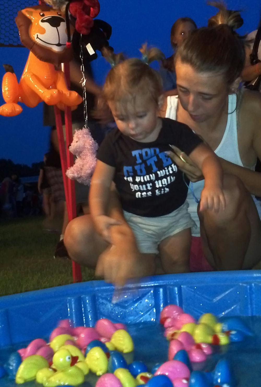 <p>Emmalynn McFadden, a 17-month-old from Hudson, Fla., plays a
game at the Williston Independence Day Festival on Saturday.</p>