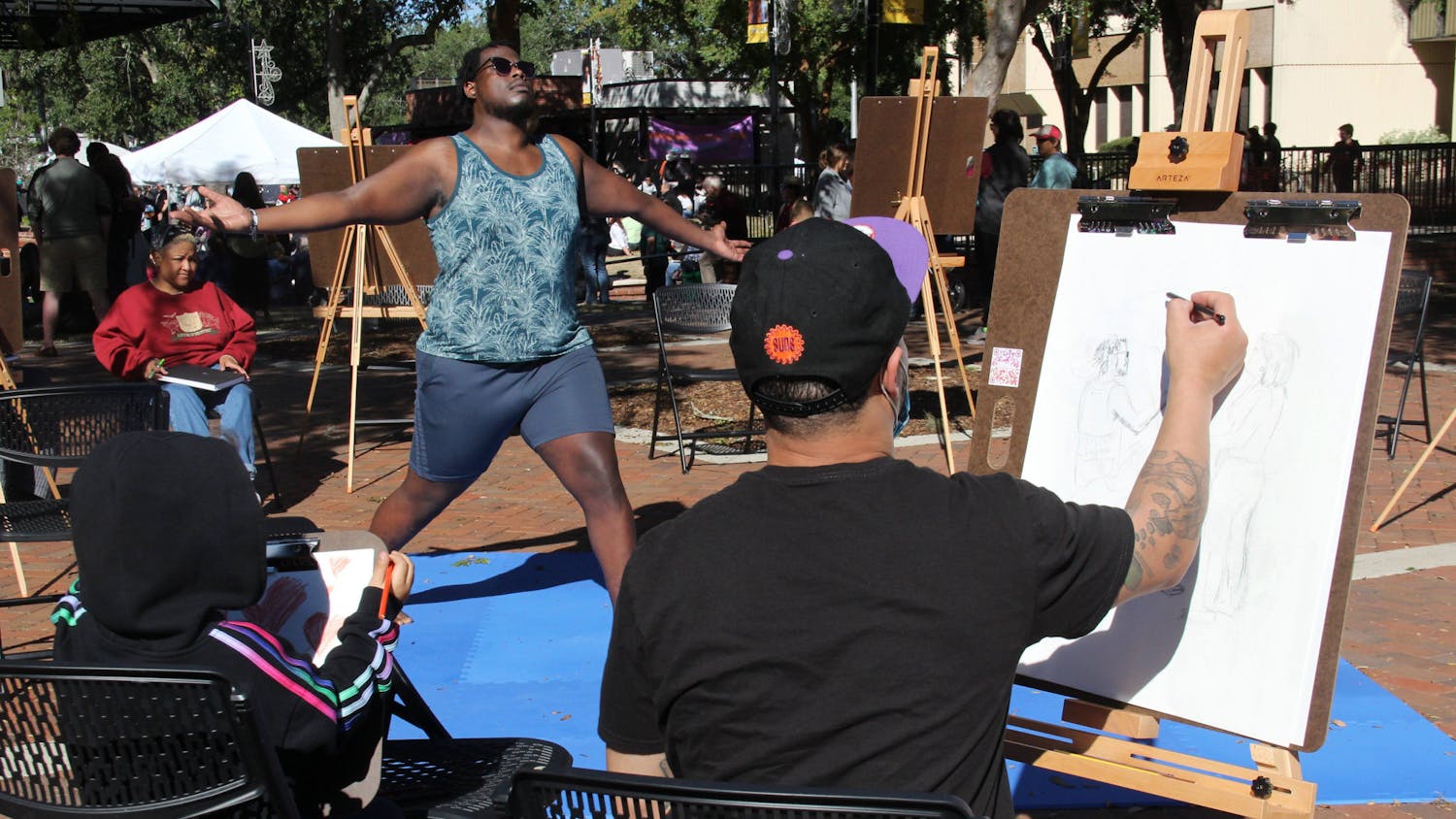 Amarisa Harrison-Conwill, (left) 5, and her father Mo Harrison-Conwill (right) draw during the 40th Downtown Festival & Art Show at Bo Diddley Plaza on Sunday, Nov. 7, 2021. "Daddy's an artist," Amarisa said.