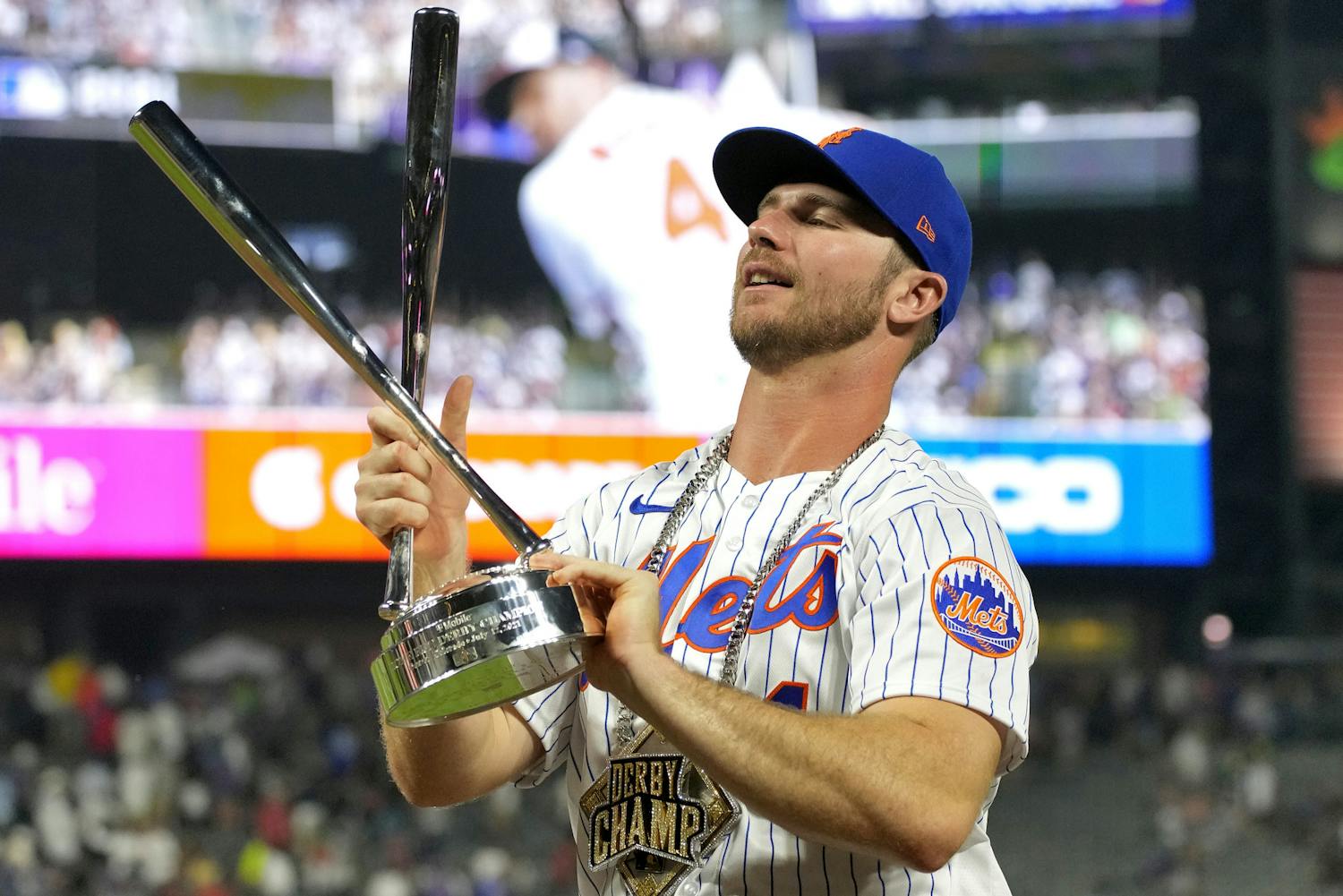 Pete Alonso holds the champions trophy after winning the MLB All Star baseball Home Run Derby, Monday, July 12, 2021, in Denver. (AP Photo/David Zalubowski)