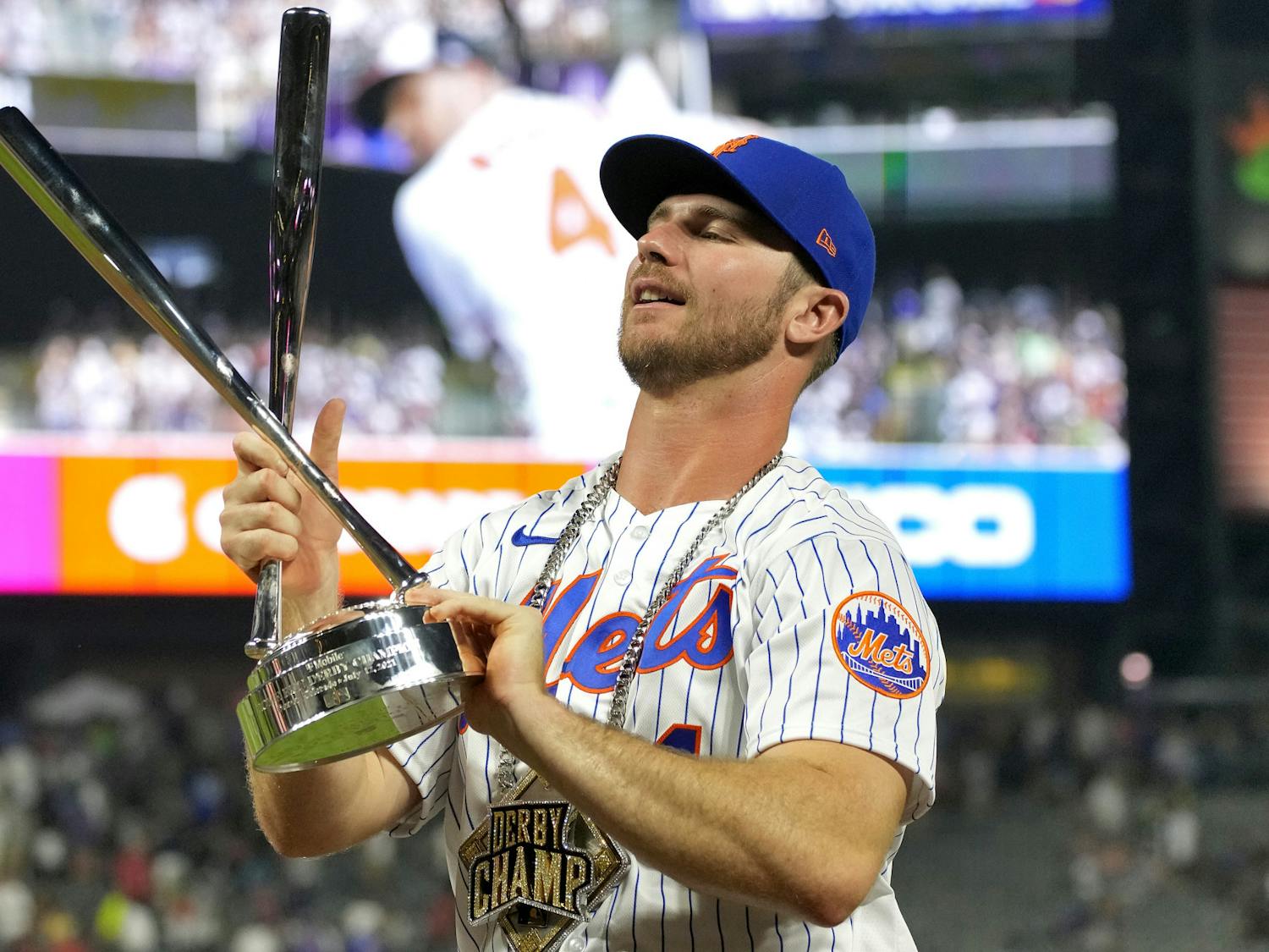 Pete Alonso holds the champions trophy after winning the MLB All Star baseball Home Run Derby, Monday, July 12, 2021, in Denver. (AP Photo/David Zalubowski)