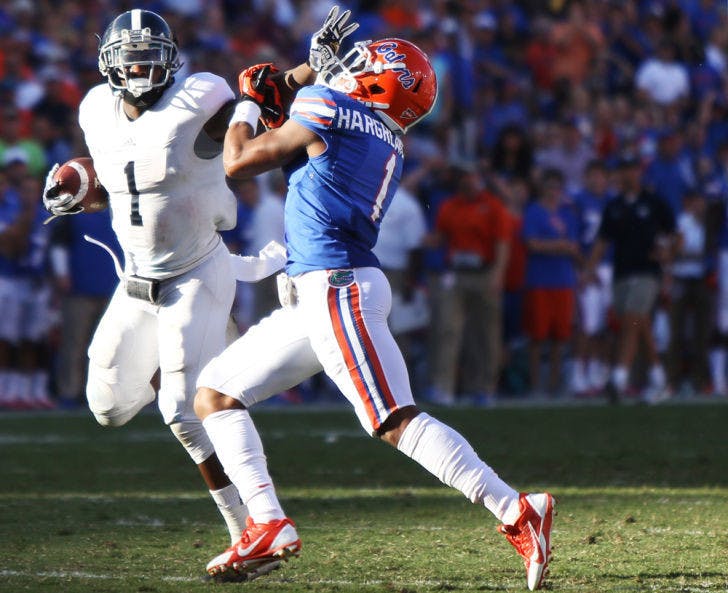 Georgia Southern quarterback Jerick McKinnon stiff arms Vernon Hargreaves III during Florida’s 26-20 loss to the Eagles on Saturday in Ben Hill Griffin Stadium. The Eagles ran for 429 yards against the Gators.