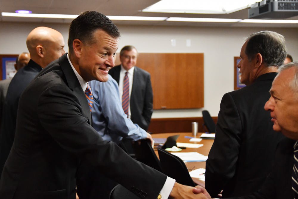 Scott Stricklin (left) greets members of the UAA board on Sept. 27, 2016.