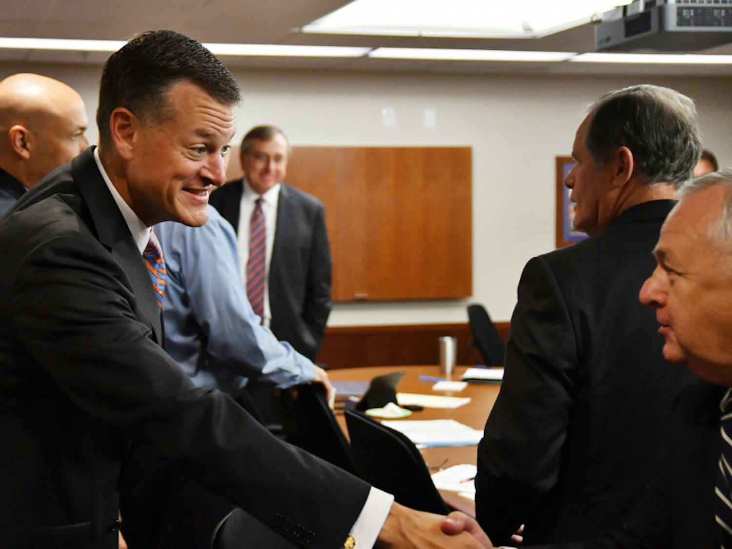 Scott Stricklin (left) greets members of the UAA board on Sept. 27, 2016.