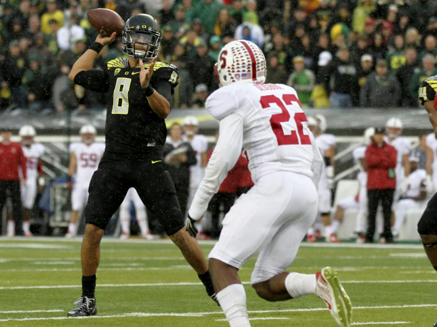 Oregon quarterback Marcus Mariota (8) looks to throw towards the end zone during the first quarter against Stanford in an NCAA college football game in Eugene, Ore., Saturday, Nov. 1, 2014. 