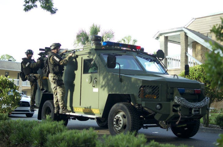 Law enforcement officers leave the Spanish Trace Apartment complex on Windmeadows Boulevard after it was cleared to be safe Wednesday afternoon. A man allegedly shot two people and then himself.
