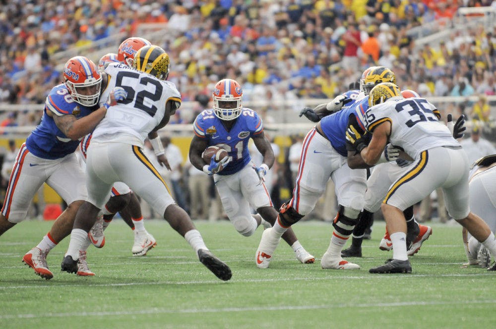 <p>UF running back Kelvin Taylor carries the ball during Florida's 41-7 loss to Michigan on Jan. 1, 2016, at the Citrus Bowl in Orlando.</p>