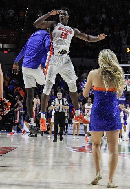 UF center John Egbunu celebrates with a teammate during Florida's 80-76 win over Georgia on Jan. 14, 2017, in the O'Connell Center.&nbsp;