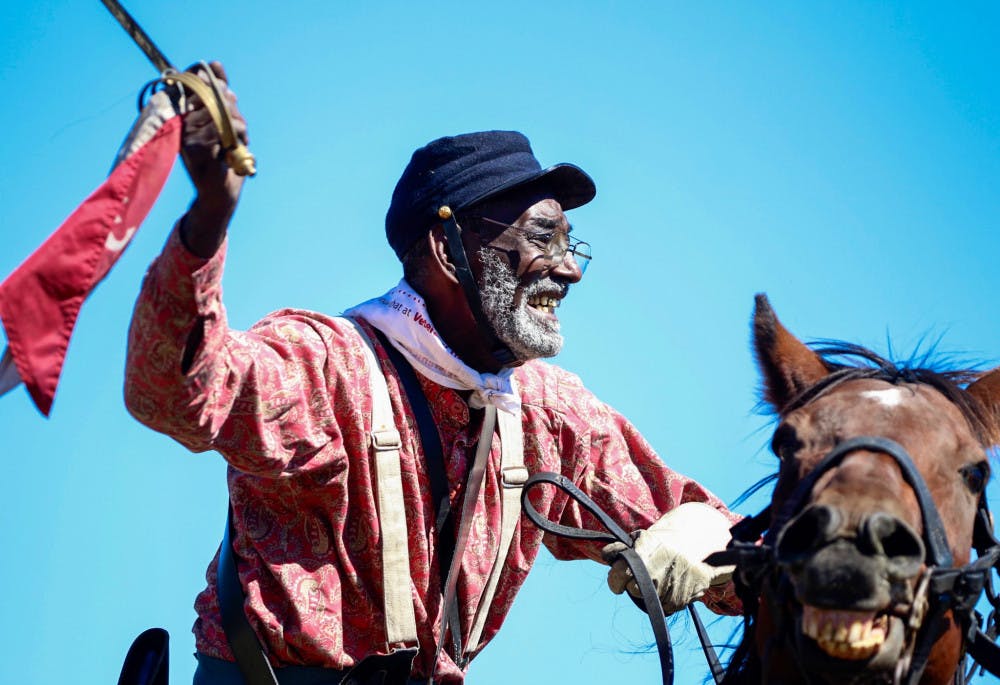 Civil War re-enactor and Vietnam War veteran Walter Anderson, 69, rides his horse, Sonney Boy, during the re-enactment. "History, don't get it twisted," Anderson said atop his horse after acting as a cavalry member for the Confederate side. "That's why I do what I do, so history can get untwisted."