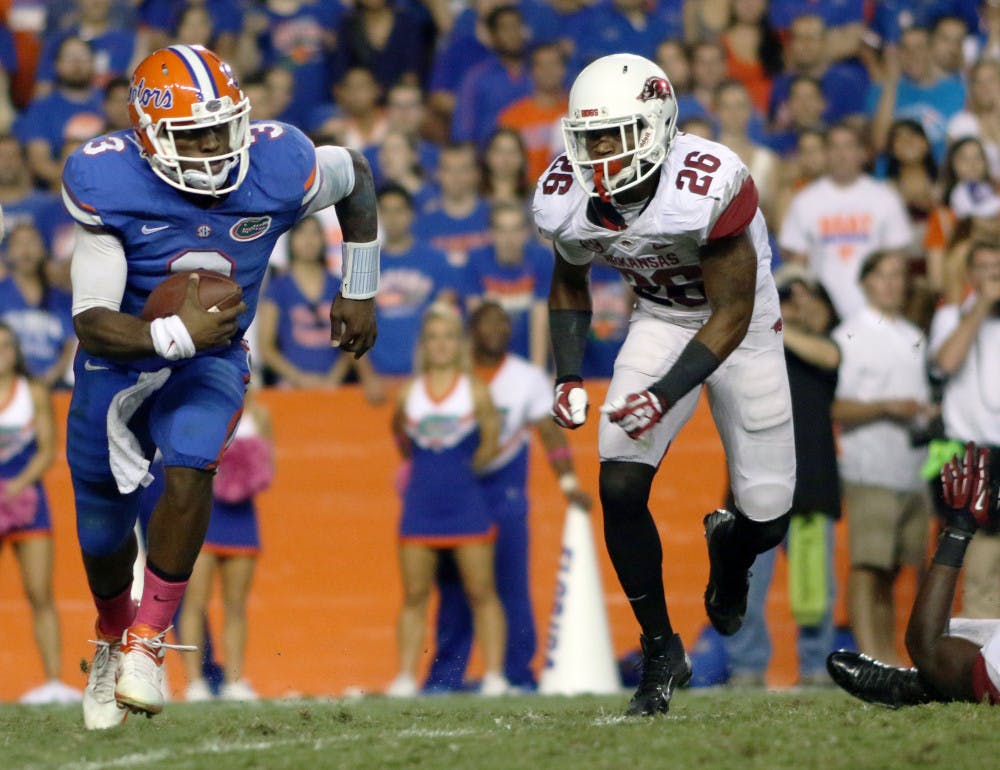 <p>Tyler Murphy runs the ball during Florida’s 30-10 victory against Arkansas on Saturday in Ben Hill Griffin Stadium. Murphy completed 16 of 22 passes for 240 yards and three touchdowns.</p>