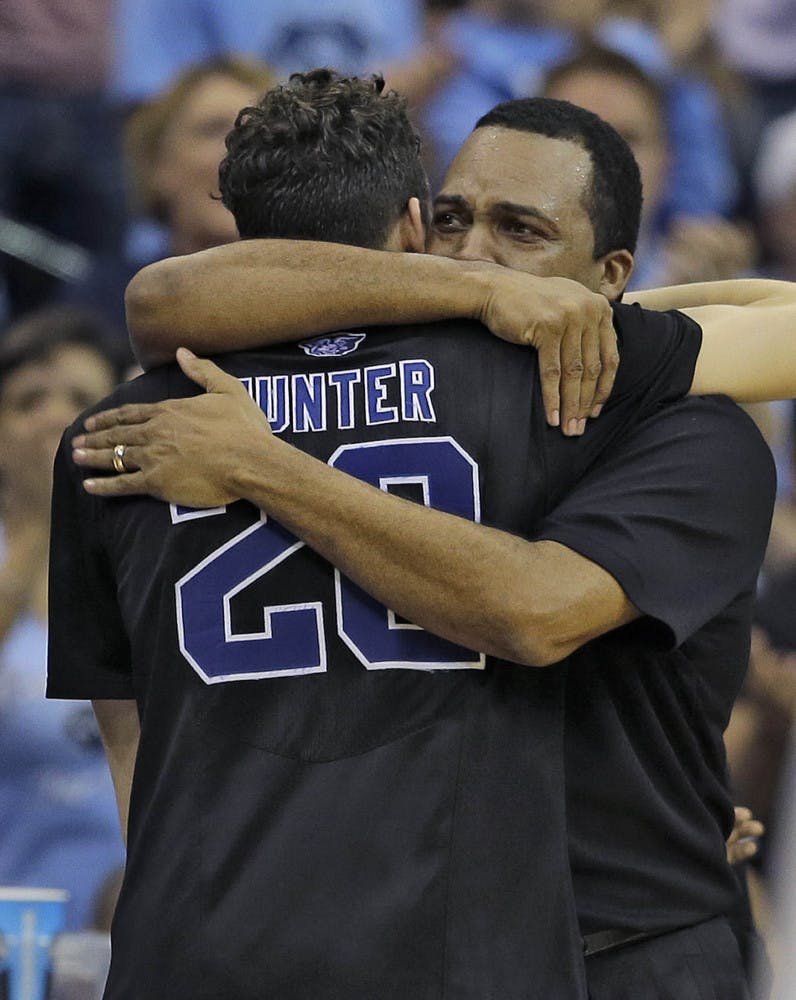 Georgia State head coach Ron Hunter hugs his son R.J. after taking him out of the game against Xavier during the second half of GSU's 75-67 loss on Saturday in the third round of the NCAA Tournament in Jacksonville.