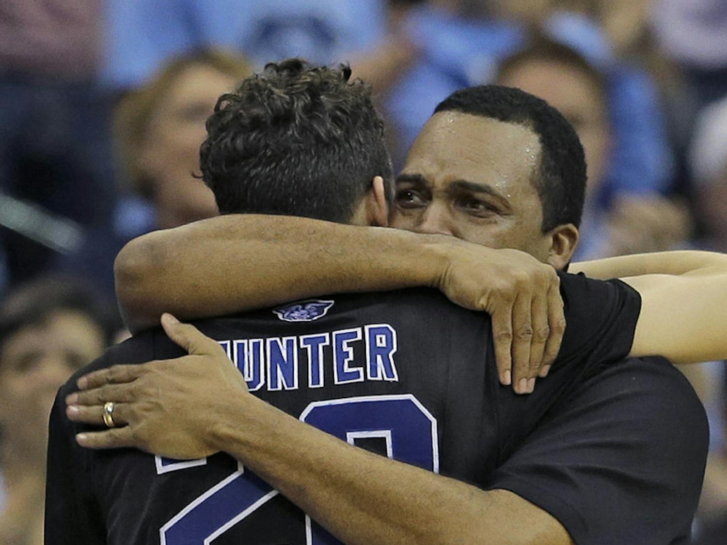 Georgia State head coach Ron Hunter hugs his son R.J. after taking him out of the game against Xavier during the second half of GSU's 75-67 loss on Saturday in the third round of the NCAA Tournament in Jacksonville.