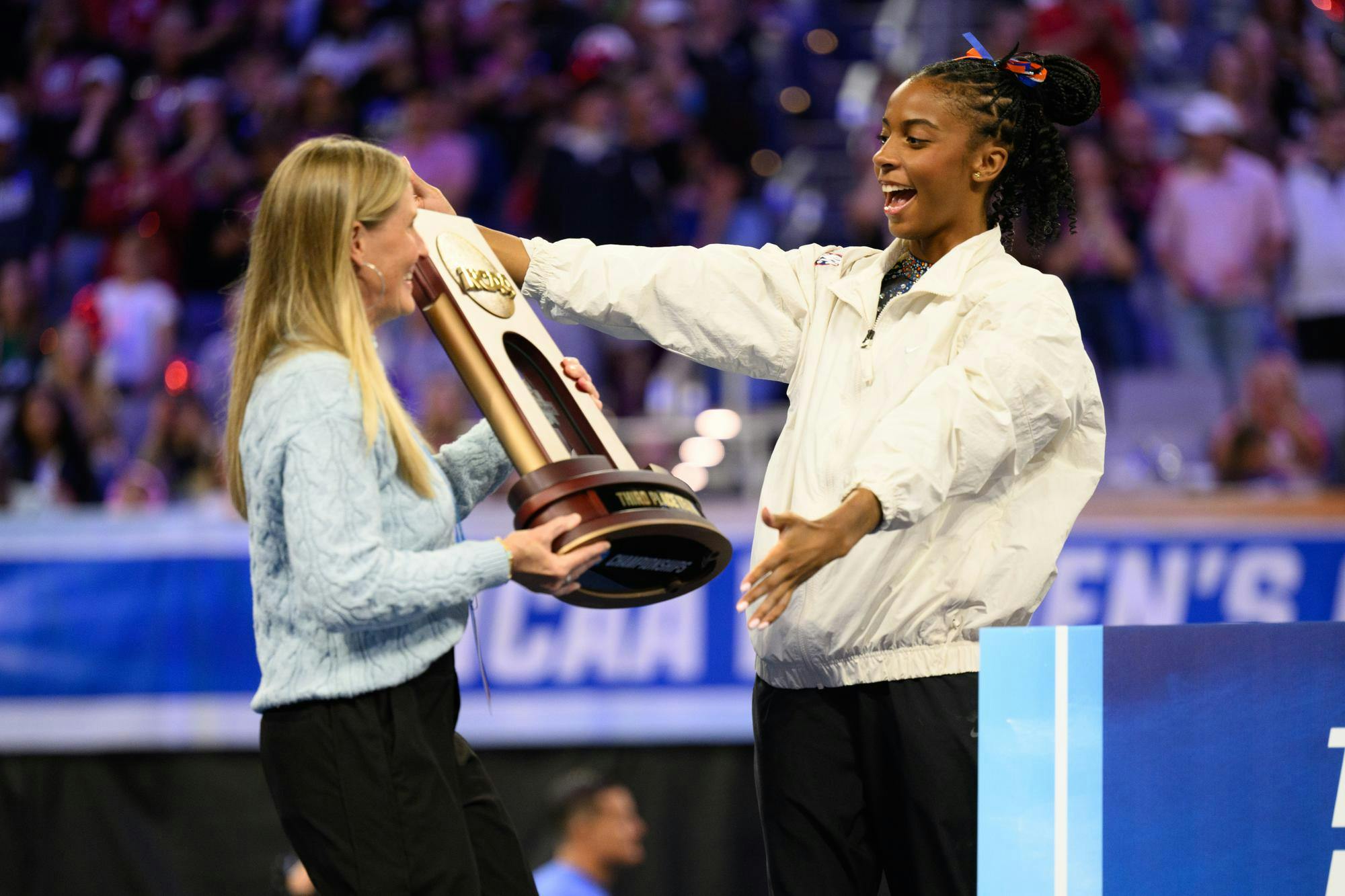 Florida gymnast Anya Pilgrim accepts the thrid place trophy after the NCAA gymnastics National Championship against Oklahoma, LSU and Minnesota, Saturday, April 18, 2026, in Fort Worth, Texas.