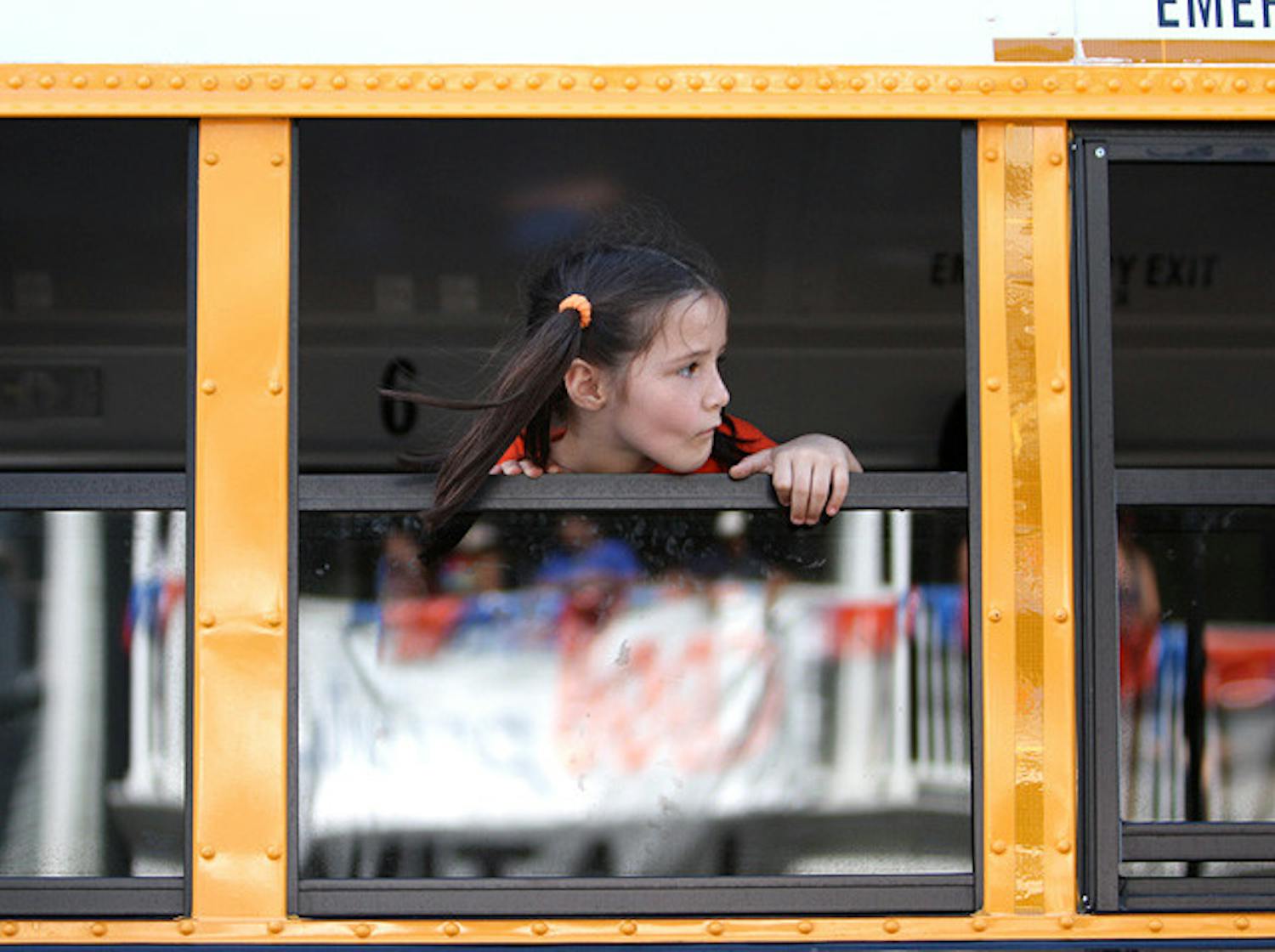 A girl stares out the window of an Alachua County school bus on West University Avenue.