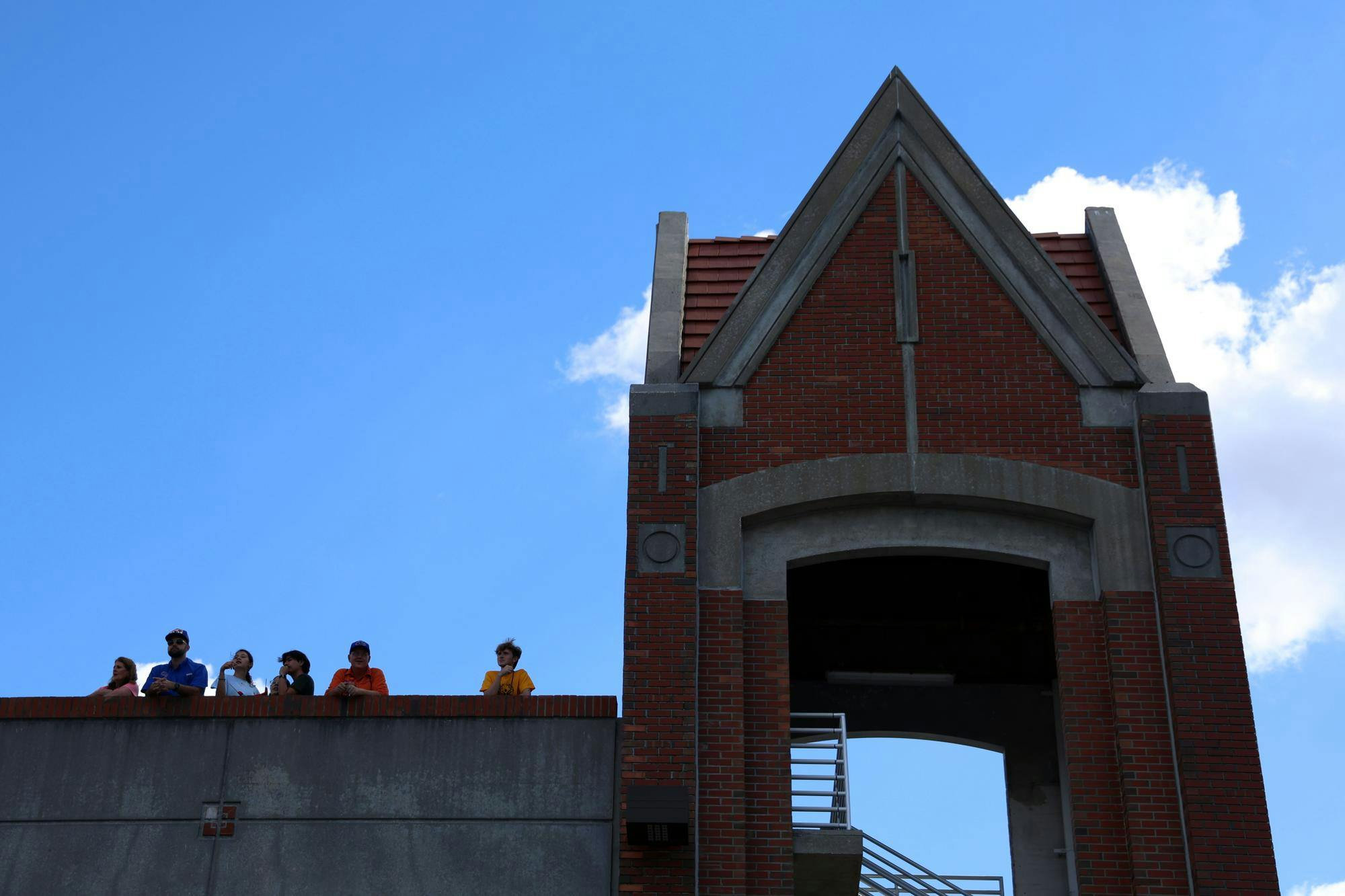 Spectators line the top level of Norman Parking Garage to get a good view of the road just before the UF Homecoming Parade on Friday, Oct. 17, 2025.