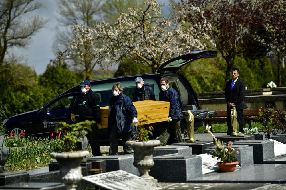 <p>Undertakers wearing protection masks to protect from the coronavirus, carry a coffin to a burial at Salvador cemetery during the coronavirus outbreak, near to Vitoria, northern Spain, Monday, March 30, 2020. The new coronavirus causes mild or moderate symptoms for most people, but for some, especially older adults and people with existing health problems, it can cause more severe illness or death. (AP Photo/Alvaro Barrientos)</p>