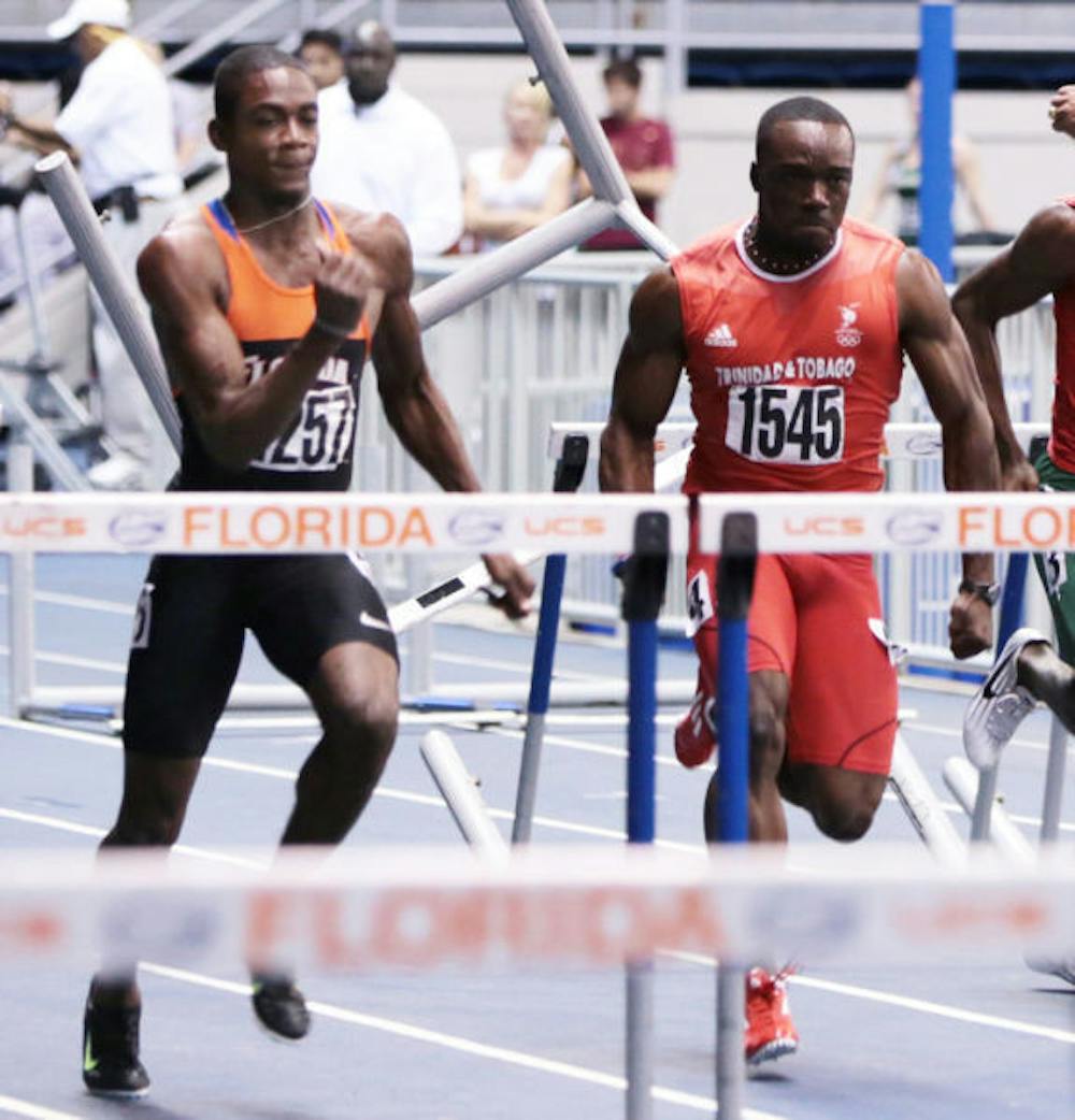 <p align="justify">Eddie Lovett (left) races in the 55m hurdles at the Gator Invitational in the O’Connell Center on Jan. 17, 2013. Lovett won the men’s 60-meter hurdles on Saturday.</p>